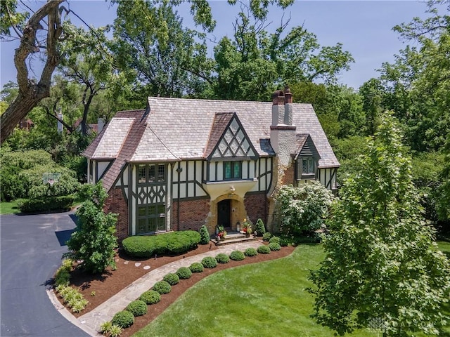 1500 Ridgeway Rd, Oakwood, OH 45419 - tudor home featuring a chimney, stucco siding, a front lawn, and brick siding