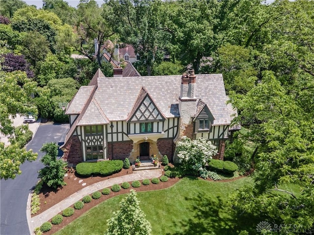 1500 Ridgeway Rd, Oakwood, OH 45419 - tudor house featuring a chimney, stucco siding, a front yard, and a high end roof