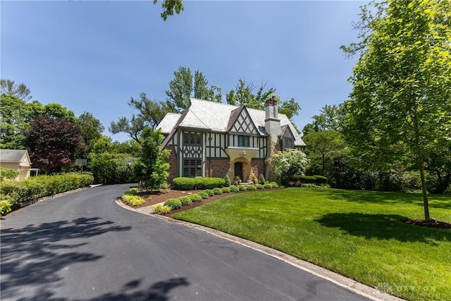 1500 Ridgeway Rd, Oakwood, OH 45419 - tudor-style house featuring a chimney and a front yard