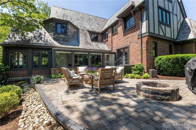 1500 Ridgeway Rd, Oakwood, OH 45419 - view of patio with an outdoor living space with a fire pit, french doors, and cooling unit