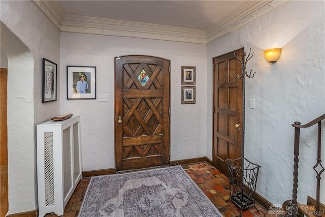 1500 Ridgeway Rd, Oakwood, OH 45419 - foyer entrance featuring brick flooring, crown molding, a textured wall, and baseboards