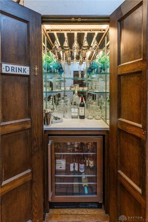 1500 Ridgeway Rd, Oakwood, OH 45419 - indoor dry bar featuring beverage cooler and a chandelier