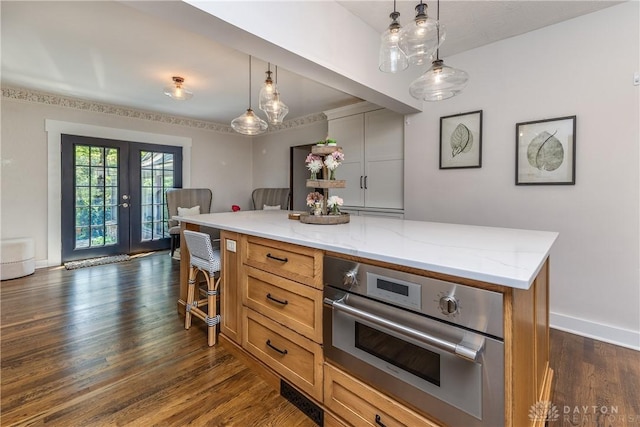1500 Ridgeway Rd, Oakwood, OH 45419 - kitchen featuring oven, french doors, light stone counters, dark wood-style floors, and brown cabinetry