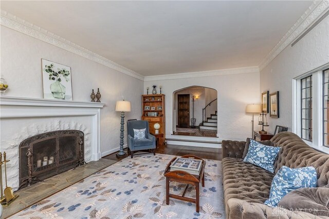 1500 Ridgeway Rd, Oakwood, OH 45419 - living area with arched walkways, a fireplace, ornamental molding, wood finished floors, and stairway