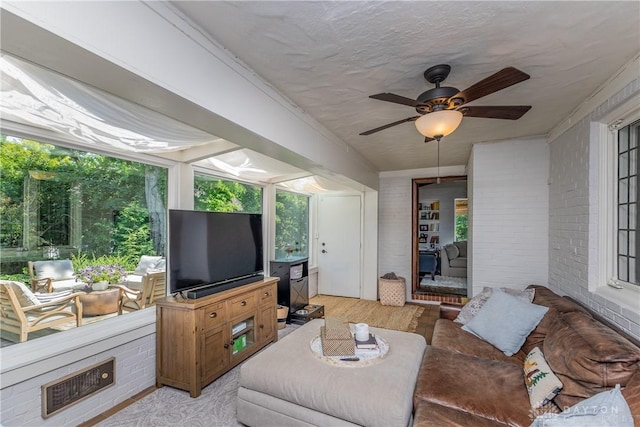 1500 Ridgeway Rd, Oakwood, OH 45419 - living room featuring a ceiling fan, brick wall, plenty of natural light, and light wood finished floors