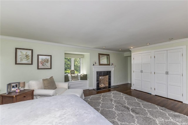1500 Ridgeway Rd, Oakwood, OH 45419 - bedroom featuring crown molding, multiple closets, a fireplace, wood finished floors, and recessed lighting