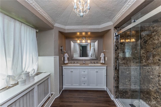 1500 Ridgeway Rd, Oakwood, OH 45419 - bathroom with double vanity, a shower stall, wood finished floors, and a chandelier