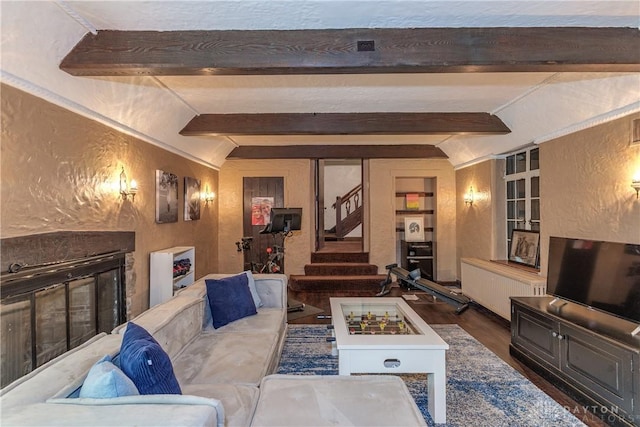 1500 Ridgeway Rd, Oakwood, OH 45419 - living room with a textured wall, wood finished floors, radiator heating unit, stairway, and a glass covered fireplace