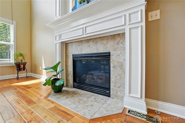 10041 Meadow Woods Ln, Washington Twp, OH 45458 - detailed view of a tile fireplace, wood finished floors, and baseboards