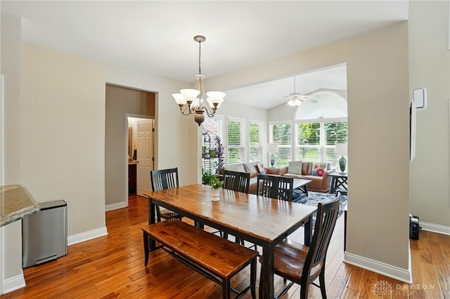 10041 Meadow Woods Ln, Washington Twp, OH 45458 - dining room with light wood-style flooring, a chandelier, baseboards, a ceiling fan, and lofted ceiling