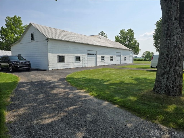 383 Georgetown Verona Rd, West Manchester, OH 45382 - view of property exterior featuring a lawn, asphalt driveway, and metal roof