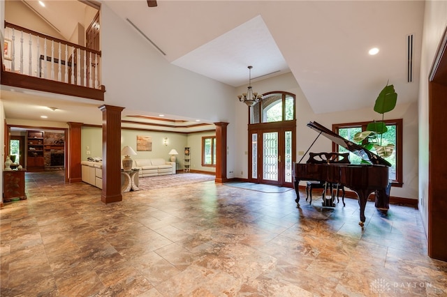1211 Runnymede Rd, Oakwood, OH 45419 - entryway with ornate columns, high vaulted ceiling, baseboards, recessed lighting, and a chandelier