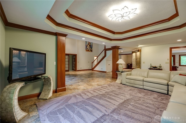 1211 Runnymede Rd, Oakwood, OH 45419 - living room with ornate columns, a tray ceiling, stairs, ornamental molding, and baseboards