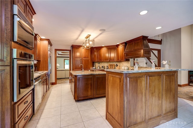 1211 Runnymede Rd, Oakwood, OH 45419 - kitchen with appliances with stainless steel finishes, a center island with sink, light tile patterned flooring, custom range hood, and backsplash