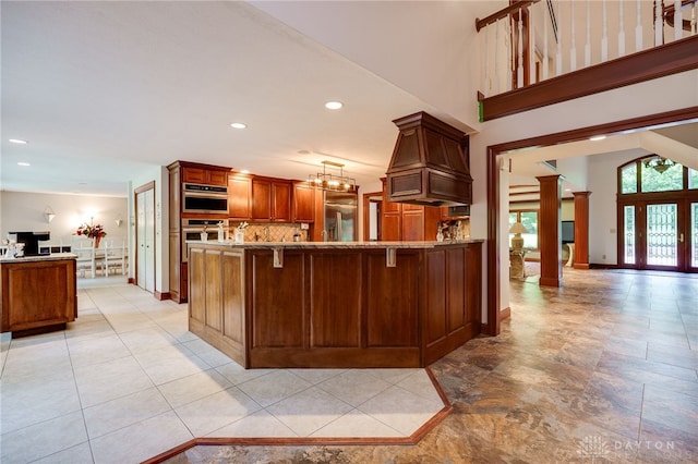 1211 Runnymede Rd, Oakwood, OH 45419 - kitchen featuring stainless steel appliances, decorative columns, a peninsula, decorative backsplash, and open floor plan