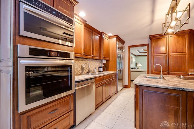 1211 Runnymede Rd, Oakwood, OH 45419 - kitchen with stainless steel appliances, a sink, decorative backsplash, light tile patterned floors, and recessed lighting