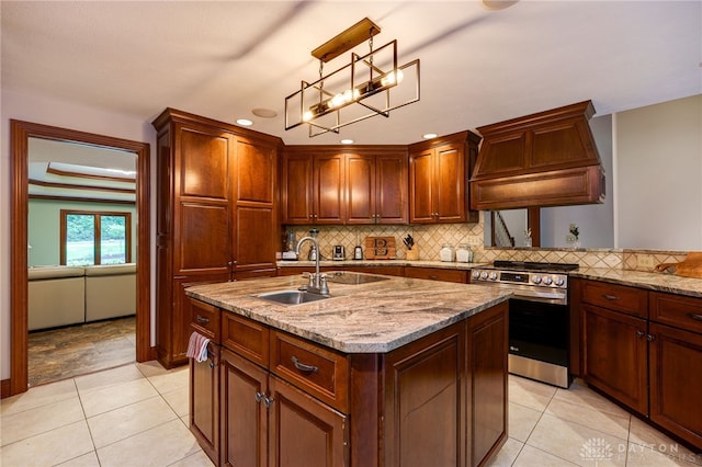 1211 Runnymede Rd, Oakwood, OH 45419 - kitchen featuring stainless steel range oven, custom exhaust hood, tasteful backsplash, light stone countertops, and a kitchen island with sink
