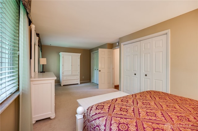 1211 Runnymede Rd, Oakwood, OH 45419 - bedroom with light colored carpet, multiple closets, and baseboards