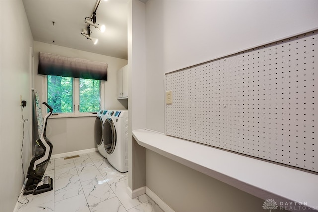 1211 Runnymede Rd, Oakwood, OH 45419 - laundry area featuring cabinet space, independent washer and dryer, light marble finish floors, baseboards, and rail lighting