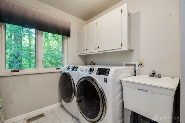 1211 Runnymede Rd, Oakwood, OH 45419 - laundry room featuring light marble finish floors, independent washer and dryer, cabinet space, and baseboards
