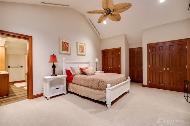 1211 Runnymede Rd, Oakwood, OH 45419 - bedroom with light carpet, lofted ceiling, multiple closets, ensuite bath, and baseboards