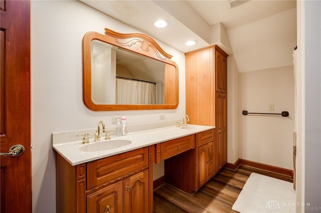 1211 Runnymede Rd, Oakwood, OH 45419 - bathroom with wood finished floors, double vanity, recessed lighting, baseboards, and vaulted ceiling