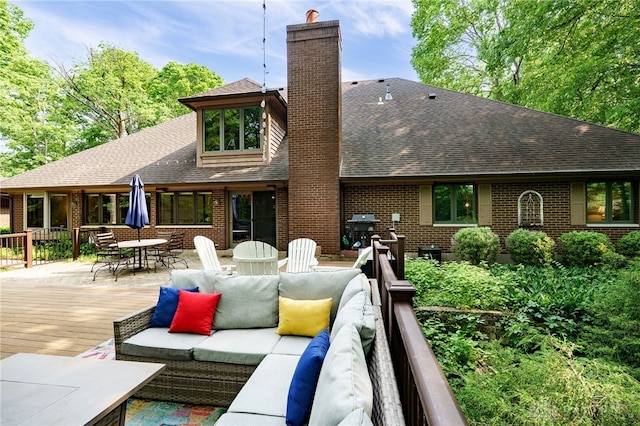 1211 Runnymede Rd, Oakwood, OH 45419 - back of house featuring a shingled roof, a chimney, outdoor dining area, an outdoor hangout area, and brick siding