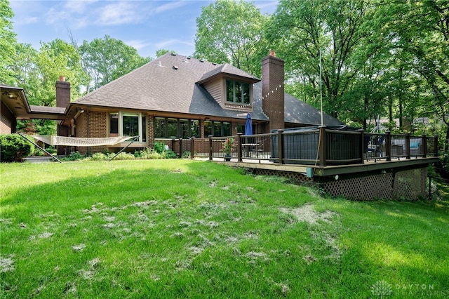 1211 Runnymede Rd, Oakwood, OH 45419 - back of property featuring a chimney, a deck, a yard, and brick siding