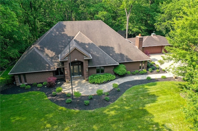 1211 Runnymede Rd, Oakwood, OH 45419 - view of front of property with brick siding, a chimney, a front yard, and roof with shingles