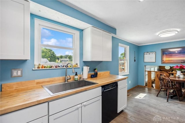 813 Ridge Rd, Englewood, OH 45322 - kitchen featuring dishwasher, butcher block counters, a sink, and white cabinetry