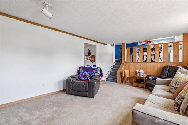 813 Ridge Rd, Englewood, OH 45322 - living area with stairs, carpet flooring, a textured ceiling, and crown molding