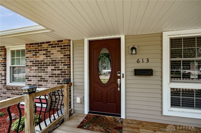 613 Spinning Rd, New Carlisle, OH 45344 - property entrance with a porch and brick siding