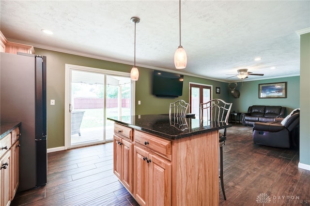 613 Spinning Rd, New Carlisle, OH 45344 - kitchen featuring freestanding refrigerator, a kitchen breakfast bar, ornamental molding, a textured ceiling, and open floor plan