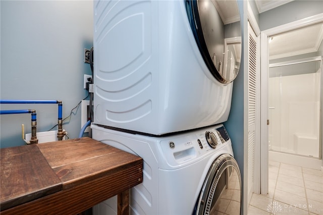 613 Spinning Rd, New Carlisle, OH 45344 - laundry room with estacked washer and dryer, ornamental molding, and light tile patterned floors