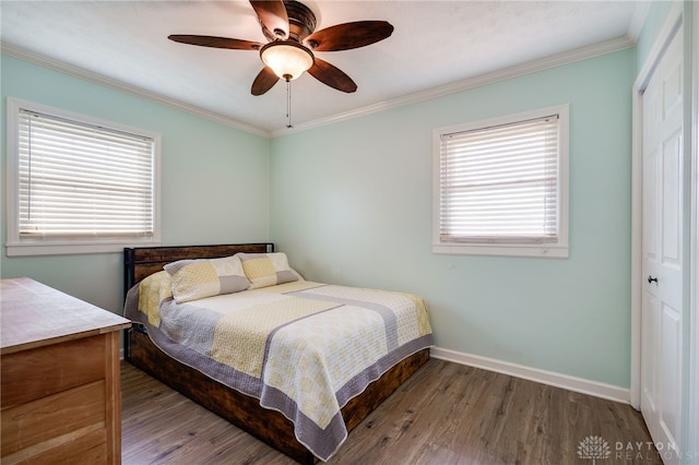 613 Spinning Rd, New Carlisle, OH 45344 - bedroom featuring a closet, wood finished floors, multiple windows, baseboards, and ornamental molding