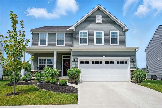 2550 Bellevue Dr, Batavia, OH 45103 - traditional-style house featuring driveway, stone siding, an attached garage, a porch, and a front lawn