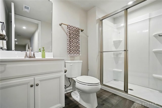 2550 Bellevue Dr, Batavia, OH 45103 - bathroom with wood finished floors, a shower stall, toilet, and vanity