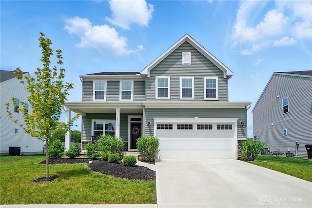 2550 Bellevue Dr, Batavia, OH 45103 - traditional-style home with concrete driveway, a front lawn, an attached garage, a porch, and central air condition unit