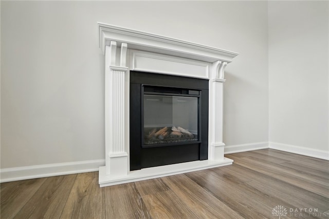 2550 Bellevue Dr, Batavia, OH 45103 - detailed view of wood finished floors, baseboards, and a glass covered fireplace