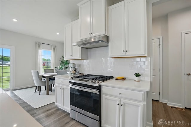2550 Bellevue Dr, Batavia, OH 45103 - kitchen featuring gas stove, under cabinet range hood, wood finished floors, light countertops, and plenty of natural light