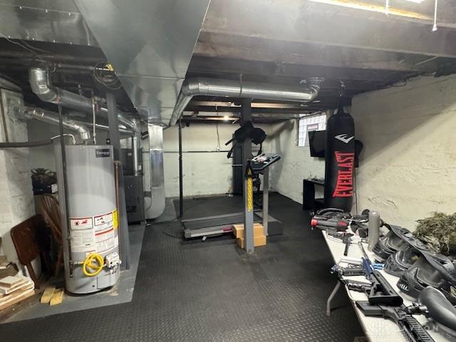 224 S Wolf Creek St, Brookville, OH 45309 - below grade area with gas water heater, heating unit, and rubber floors