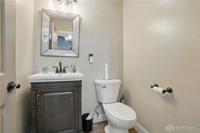 712 S Linden Ave, Miamisburg, OH 45342 - bathroom with vanity, toilet, baseboards, and wood finished floors