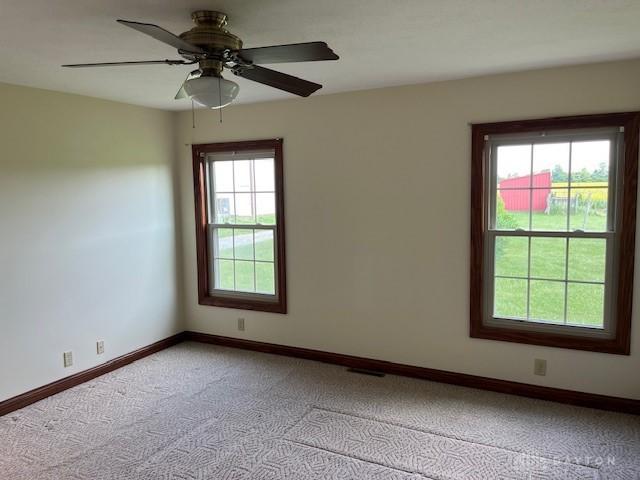 5671 Sonora Rd, Lewisburg, OH 45338 - unfurnished room featuring light colored carpet, baseboards, and ceiling fan
