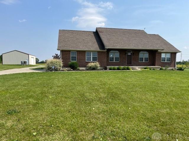 5671 Sonora Rd, Lewisburg, OH 45338 - view of front of property with a detached garage, a front lawn, and brick siding