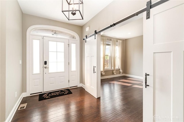 5411 Whispering Brook Ct, Liberty Twp, OH 45011 - entryway featuring a barn door, dark wood finished floors, baseboards, and a chandelier