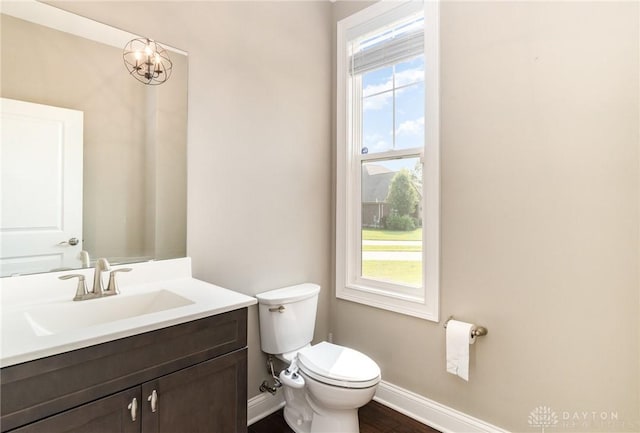 5411 Whispering Brook Ct, Liberty Twp, OH 45011 - bathroom featuring baseboards, toilet, vanity, and wood finished floors