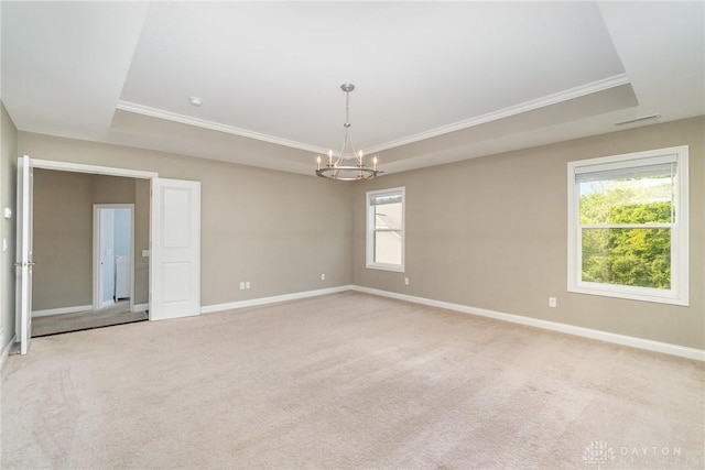 5411 Whispering Brook Ct, Liberty Twp, OH 45011 - unfurnished room with a chandelier, a tray ceiling, baseboards, light colored carpet, and crown molding
