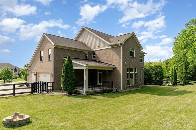 5411 Whispering Brook Ct, Liberty Twp, OH 45011 - rear view of house featuring an attached garage, a fire pit, and brick siding