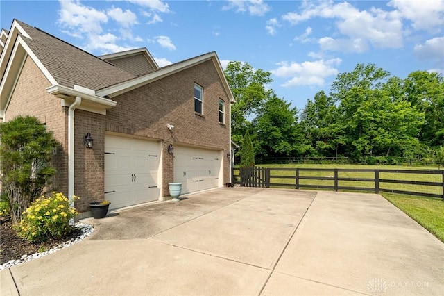5411 Whispering Brook Ct, Liberty Twp, OH 45011 - view of home's exterior featuring brick siding, driveway, and a garage