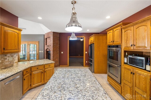 4384 New Market Banta Rd, Lewisburg, OH 45338 - kitchen featuring stainless steel appliances, light tile patterned floors, light stone counters, hanging light fixtures, and backsplash